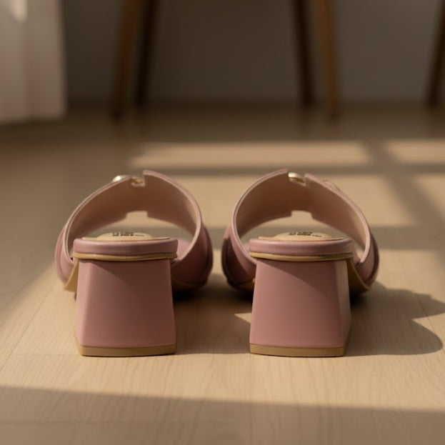 Pair of pink sandals on a wooden floor with soft lighting