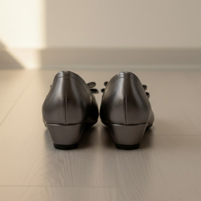 Pair of grey shoes on a light wooden floor