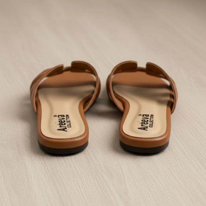 Pair of brown sandals with 'Areeva' branding on a beige surface