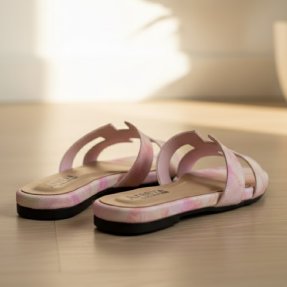 Pair of pink flipper on a light wooden floor with a soft focus background