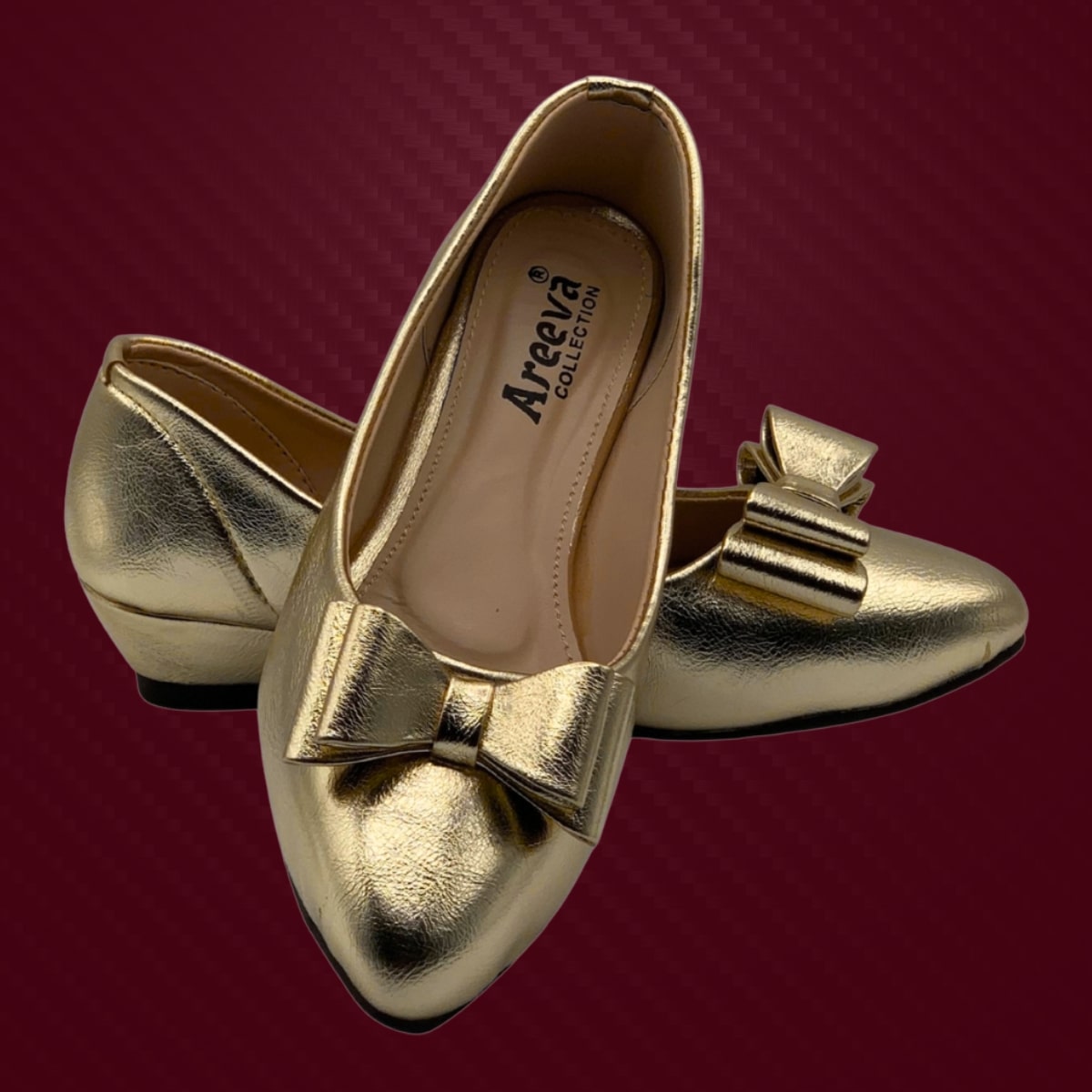 Gold shoes with bow detail on a red background