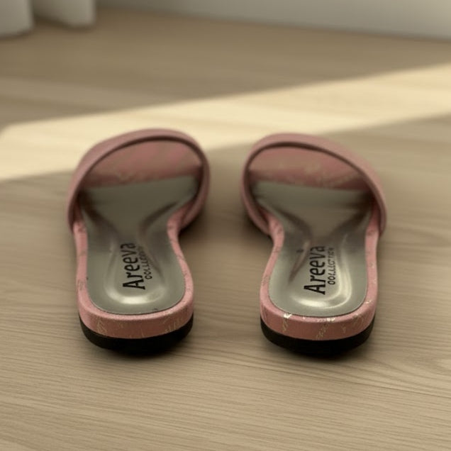 Pair of pink sandals with 'Areeva' branding on a wooden floor.