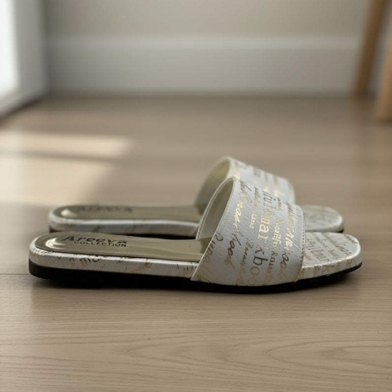 Pair of white slides with text design on a wooden floor