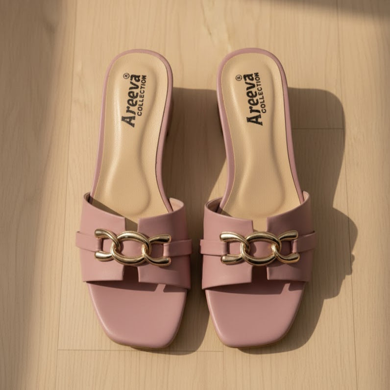Pair of pink slides with gold chain detail on a wooden surface, featuring the Areeva Collection logo.
