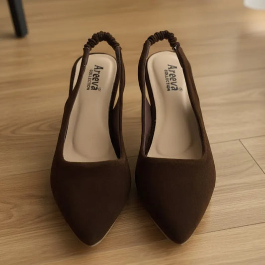 Pair of brown high-heeled shoes with 'Areeva' branding on a wooden floor.