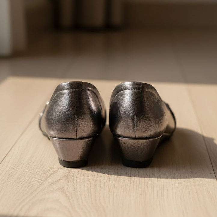 Pair of grey shoes on a wooden floor