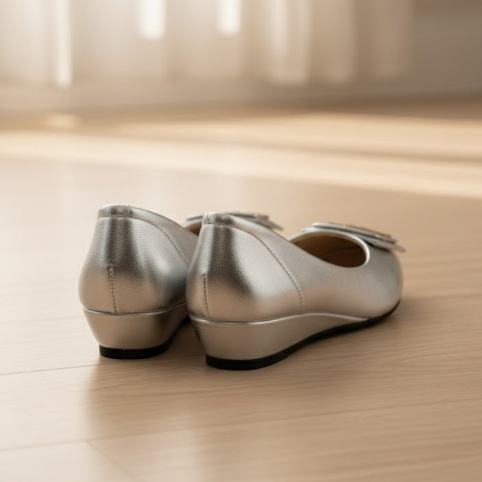Pair of silver shoes on a wooden floor