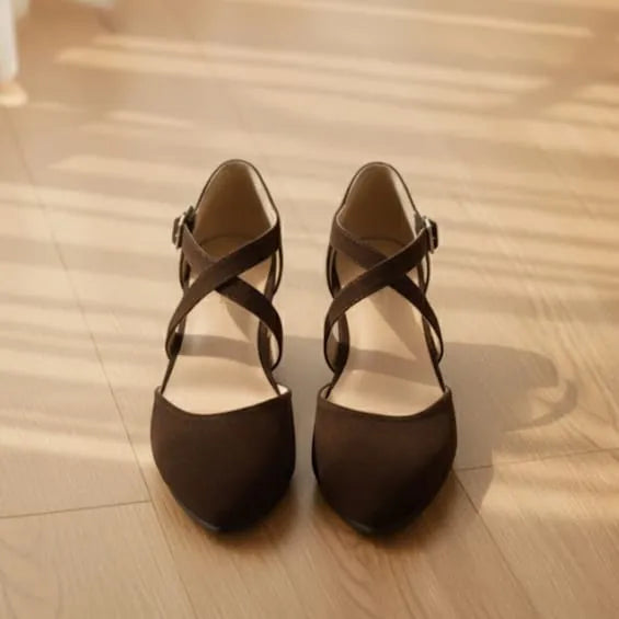 Pair of brown  shoes on a wooden floor