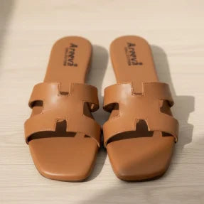 Pair of brown Flipper on a light wooden floor