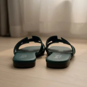 Pair of green Flipper on a wooden floor with a neutral background