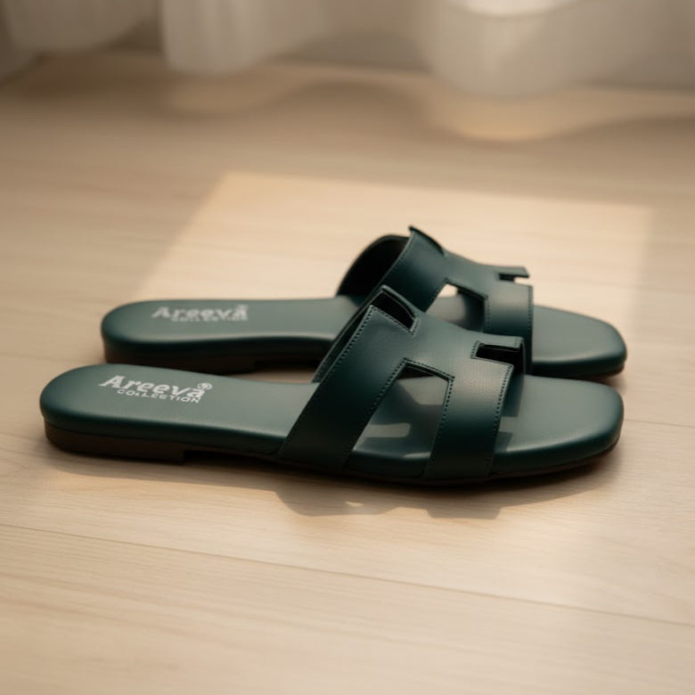 Pair of green sandals with 'Areva' branding on a wooden floor.