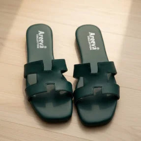 Green Flipper with Areeva branding on a light wooden floor.