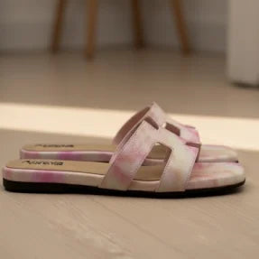 Pair of pink  slippers on a wooden floor.