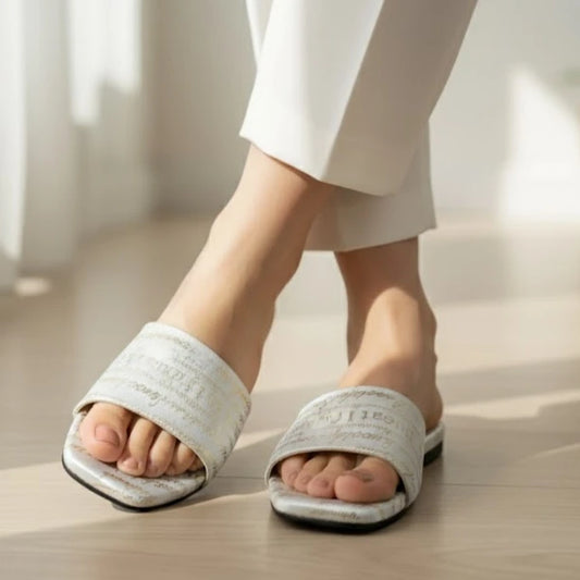 White slippers worn on feet with a blurred background