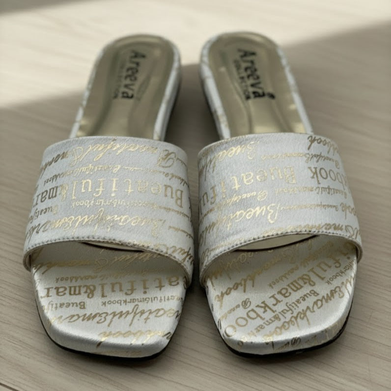 Pair of white slides with text on a wooden surface