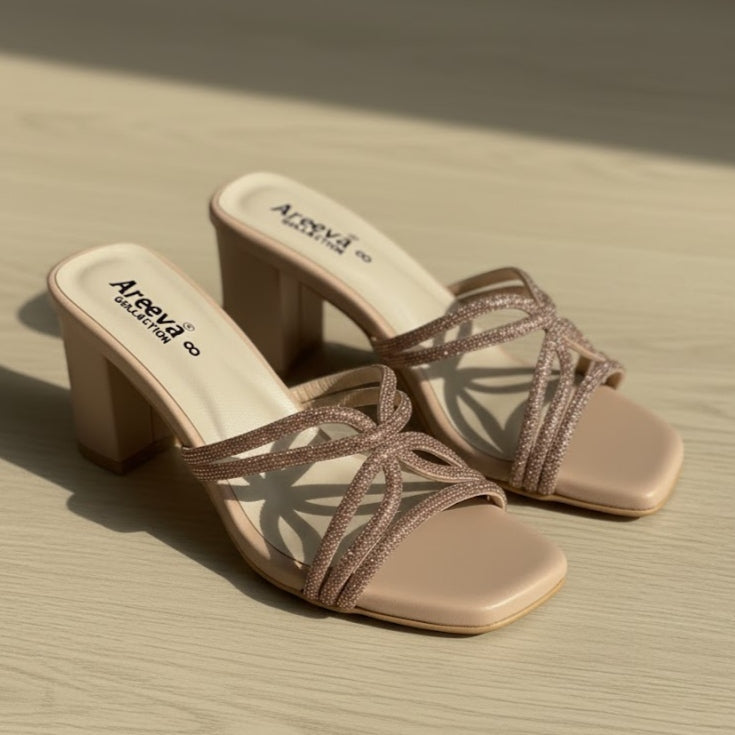 Pair of beige high-heeled sandals with 'Alpeva' branding on a beige surface.